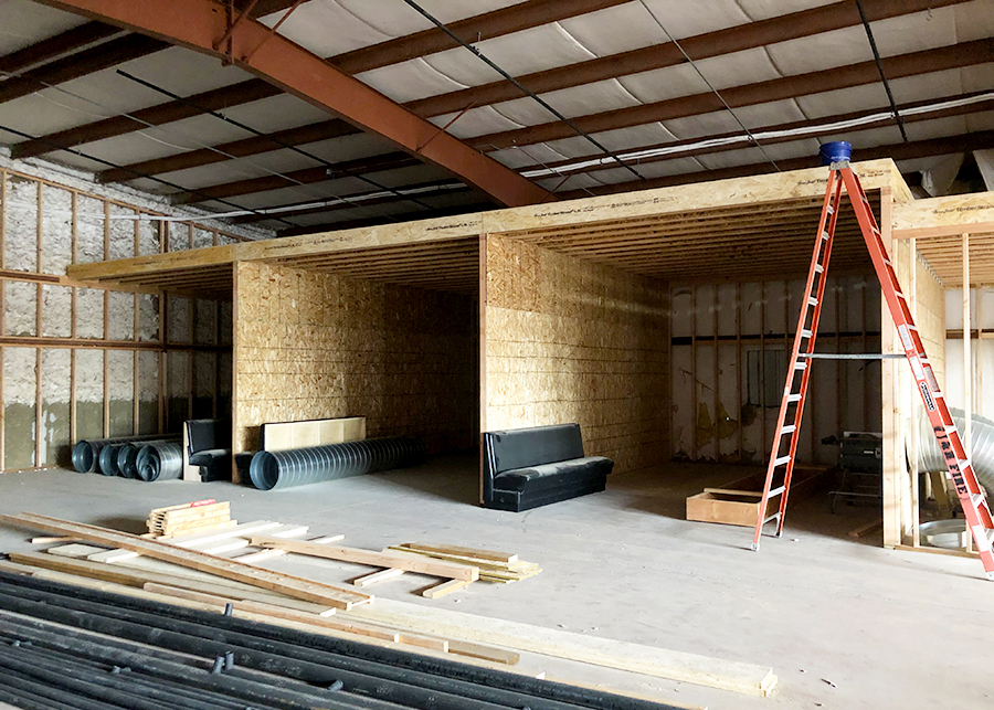 A construction photo of the interior of the building clearly showing the spaces that will serve as virtual, indoor driving ranges